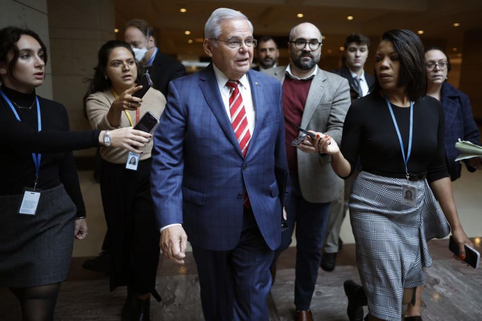 A photo including Senator Bob Menendez talking to Journalists at the U.S Capitol