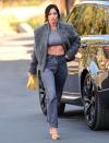 <p>Megan Fox runs errands in a cropped top, coat and jeans out in Encino, California on Thursday.</p>