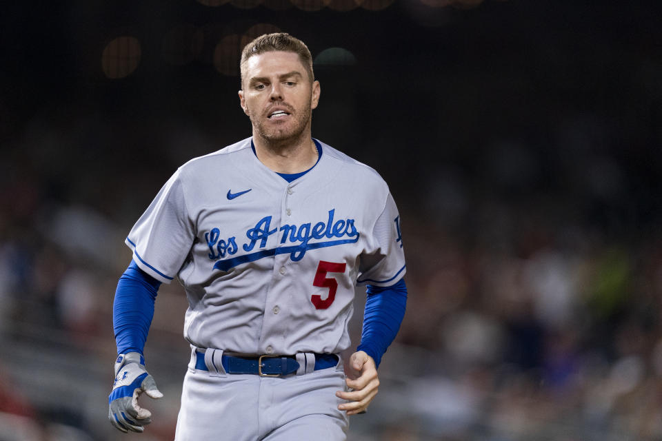 Los Angeles Dodgers' Freddie Freeman runs toward home to score on an RBI single by teammate Max Muncy during the sixth inning of a baseball game against the Washington Nationals, Friday, Sept. 8, 2023, in Washington. (AP Photo/Stephanie Scarbrough)