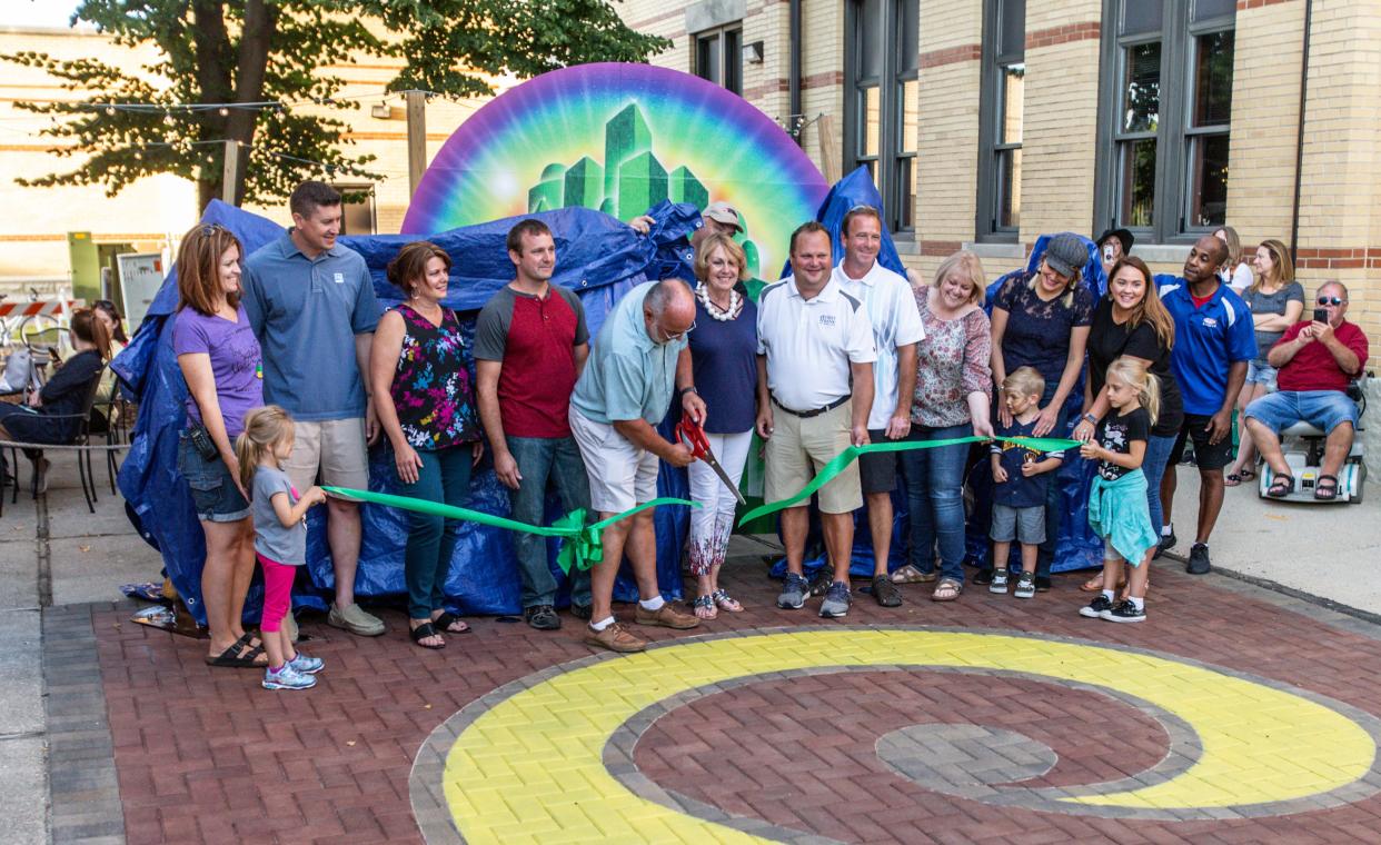 Mayor Dave Nold cuts the ribbon on Oconomowoc's Wizard of Oz Plaza during the 80th anniversary celebration of "The Wizard of Oz" premiere on Thursday, August 15, 2019. The event featured family activities, food, games, costume contests and a screening of "The Wizard of Oz" movie on a giant outdoor screen.
