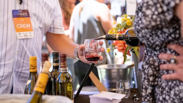 pouring wine at tasting table