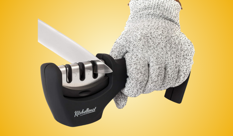 a gloved hand using the knife sharpener