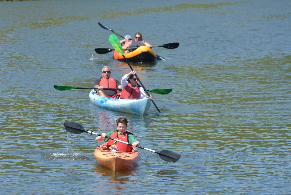 Cameron Zanchi, 14, of Douglas, paddles down the Swan River with his parents Kerri and James Zanchi following in the kayak behind him. The Zanchis rented kayaks from Cape Cod Waterways on Sunday. Cape Cod Waterways offers kayak, stand-up paddleboard, canoe and pedal boat rentals on the Swan River in Dennis Port.