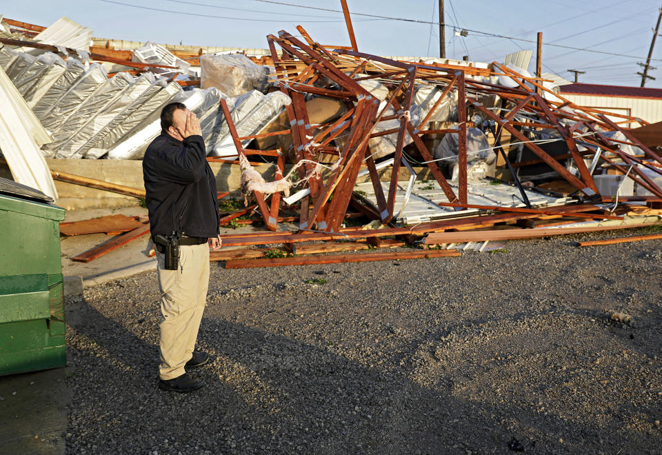 Justin Sloggett views the damage to his parents' business, Saving Place Rustic Furniture and Mattress, in Sapulpa, Okla., on May 26. (Photo: Mike Simons/Tulsa World via AP)