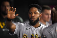 Oakland Athletics' Elvis Andrus celebrates in the dugout after scoring against the Los Angeles Angels during the seventh inning of a baseball game in Anaheim, Calif., Thursday, July 29, 2021. (AP Photo/Kelvin Kuo)