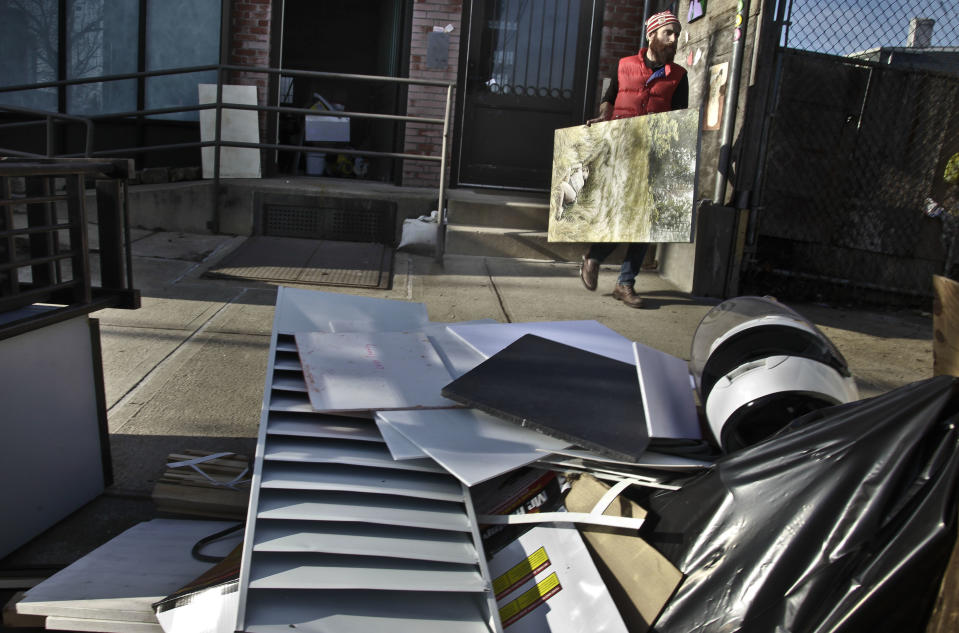 John Gordon Gauld, an artist who lost paintings during superstorm Sandy, moves a painting out of his Red Hook studio on Monday, Dec. 3, 2012 in New York. (AP Photo/Bebeto Matthews)