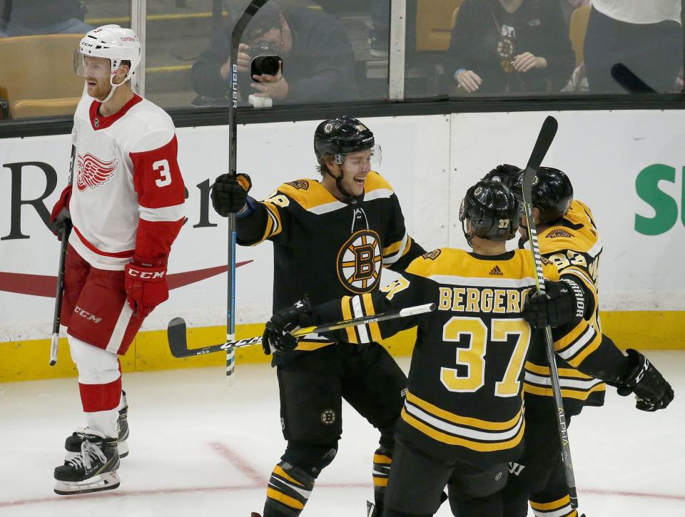 <p>
              Boston Bruins right wing David Pastrnak celebrates his third goal of an NHL hockey game with teammates Patrice Bergeron (37) and Brad Marchand as Detroit Red Wings defenseman Nick Jensen (3) skates by during the third period Saturday, Oct. 13, 2018, in Boston. (AP Photo/Mary Schwalm)
            </p>