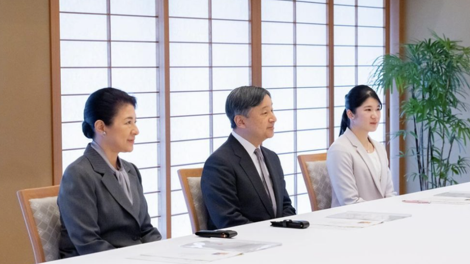 The Japanese royal family sit at a banquet table