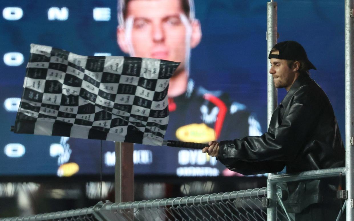 November 18, 2023 Singer Justin Bieber waves the checkered flag as Red Bull's Max Verstappen wins the race