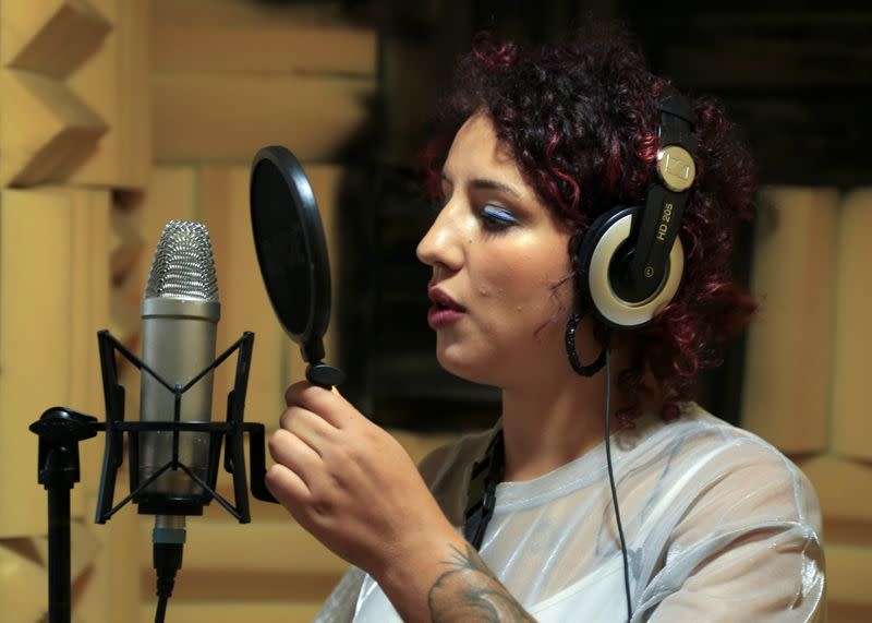 Moroccan rapper Houda Abouz, 24, known by her stage name "Khtek", records a song inside a studio in Rabat