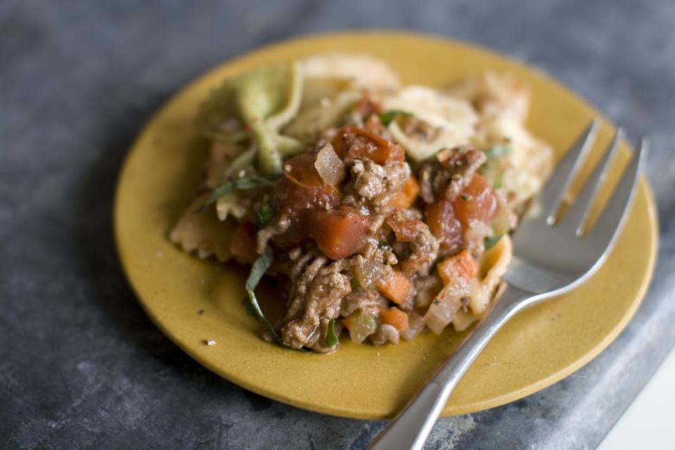 This Dec. 2, 2013 photo shows five spice pork bolognese pasta in Concord, N.H. This Bolognese is mostly effortless. You can make it even more so by using the food processor to chop your vegetables. Just toss them all in at once, then pulse until finely chopped. As for the meat, pork is delicious, but feel free to substitute beef, veal or turkey. (AP Photo/Matthew Mead)