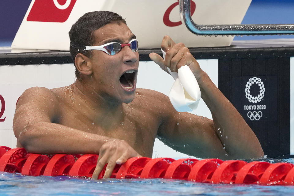 Ahmed Hafnaoui, of Tunisia, celebrates after winning the final of the men's 400-meter freestyle at the 2020 Summer Olympics, Sunday, July 25, 2021, in Tokyo, Japan. (AP Photo/Martin Meissner)