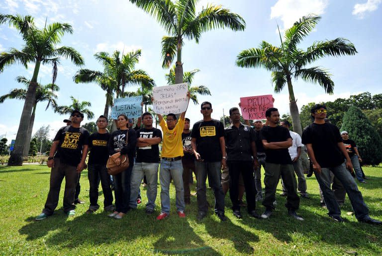 Malaysian students display placards during a protest outside the Election Commission offices in Putrajaya on May 10, 2013. A planned wave of protests over disputed Malaysian elections is the most provocative challenge to the government in years, upping pressure on a long-ruling regime already smarting from the polls