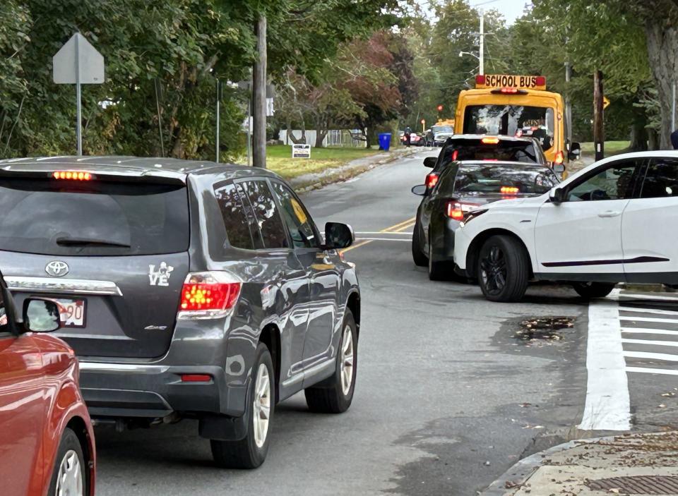 A driver attempts to exit a Taunton High School driveway onto a traffic congested Williams Street after classes are dismissed on Oct. 10.