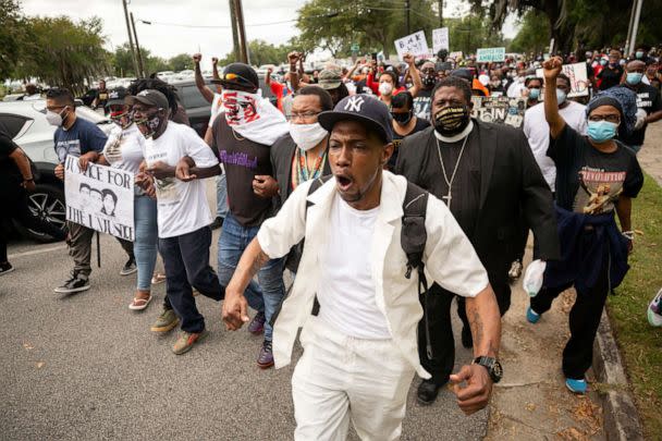 PHOTO: Malik Muhammad, center, joins a group of people marching from the Glynn County Courthouse in downtown to a police station after a rally to protest the shooting of Ahmaud Arbery, Saturday, May 16, 2020, in Brunswick, Ga. (Stephen B. Morton/AP)