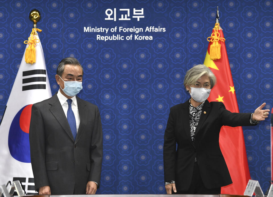 South Korean Foreign Minister Kang Kyung-wha, right, gestures to Chinese Foreign Minister Wang Yi, prior their meeting at the foreign ministry in Seoul, South Korea, Thursday, Nov. 26, 2020. Wang arrived in Seoul on Nov. 25, for a three-day state visit.(Kim Min-hee/Pool Photo via AP)