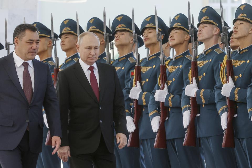 Russian President Vladimir Putin, front right, and Kyrgyzstan's President Sadyr Japarov, front left, attend a military welcome ceremony prior to their talks in Bishkek, Kyrgyzstan, Thursday, Oct. 12, 2023. (Sergei Karpukhin, Sputnik, Kremlin Pool Photo via AP)