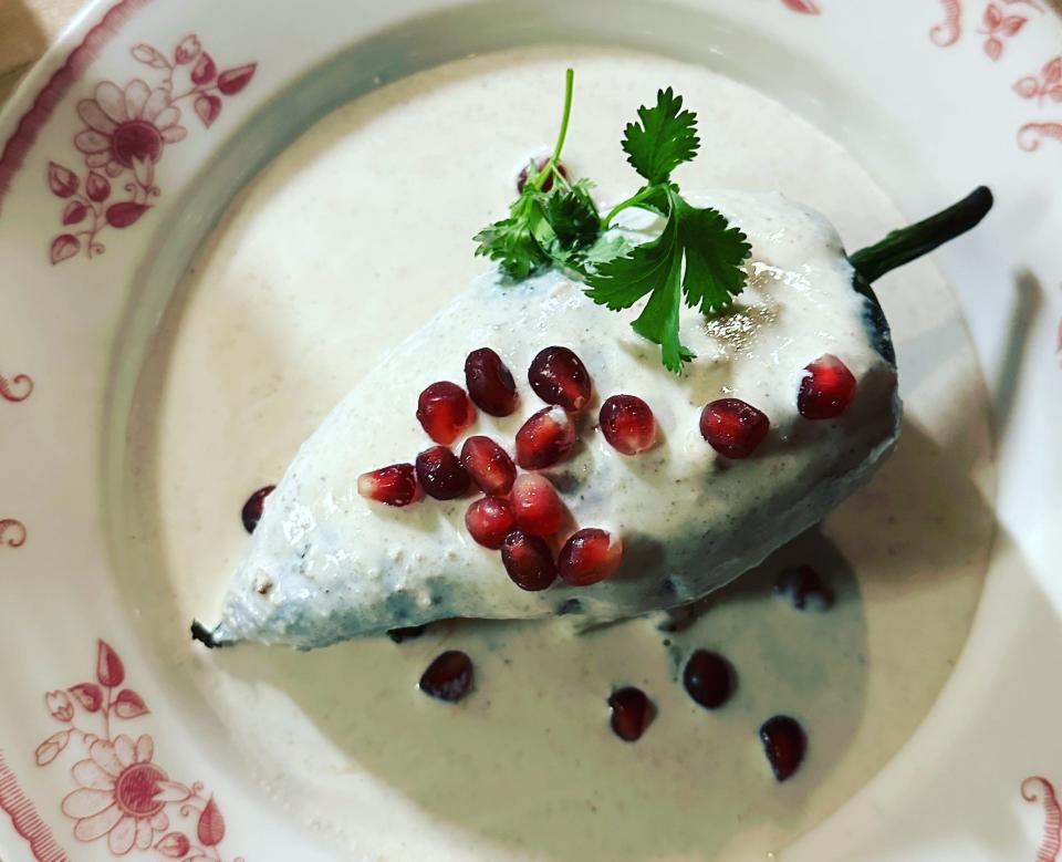 The chile en nogada with mushroom nogada filling, creamy walnut sauce and pomegranates at Meximodo.