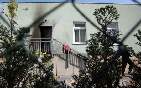 Police inspect the front of a mosque in Dresden, Germany on September 27, 2016, one day after an improvised bomb destroyed the entrance. REUTERS/Matthias Schumann