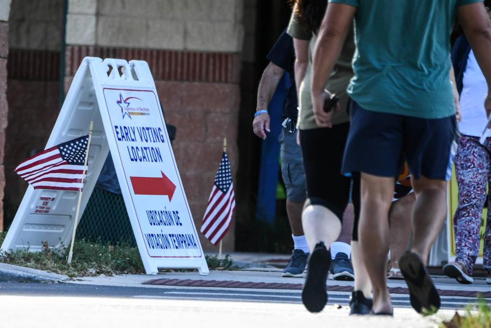 People enter and leave the early voting location at Viera Regional Park Community Center in Melbourne, Florida, on Nov. 4, 2022.