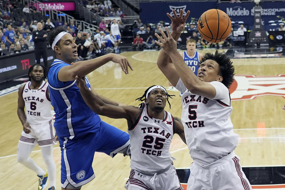 BYU center Aly Khalifa (50) passes over Texas Tech guard Darrion Williams (5) during the first half of an NCAA college basketball game Thursday, March 14, 2024, in Kansas City, Mo. (AP Photo/Charlie Riedel)