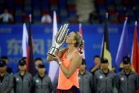 Tennis - Wuhan Open Women's Singles final - Wuhan, Hubei Province, China - 01/10/16. Petra Kvitova of Czech Republic kisses her trophy after beating Dominika Cibulkova of Slovakia. REUTERS/Darley Shen