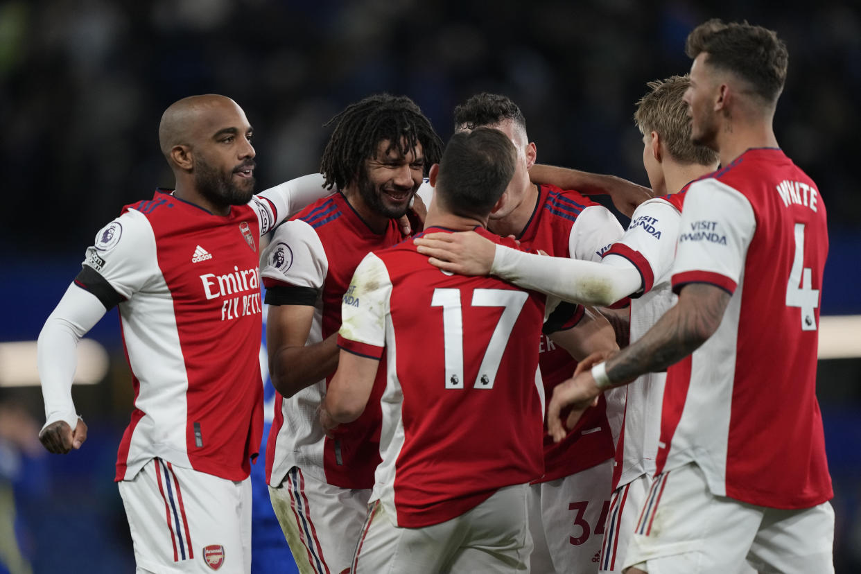 Arsenal players celebrate after the end of the English Premier League soccer match between Chelsea and Arsenal at Stamford Bridge in London, Wednesday, April 20, 2022, Arsenal won the game 4-2. (AP Photo/Frank Augstein)