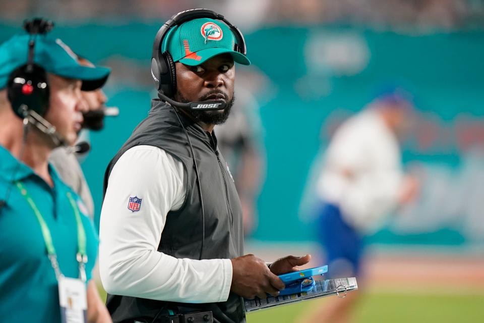 Miami Dolphins head coach Brian Flores guides his team from the sideline during the second half of an NFL football game against the New England Patriots, Sunday, Jan. 9, 2022, in Miami Gardens, Fla. (AP Photo/Wilfredo Lee)