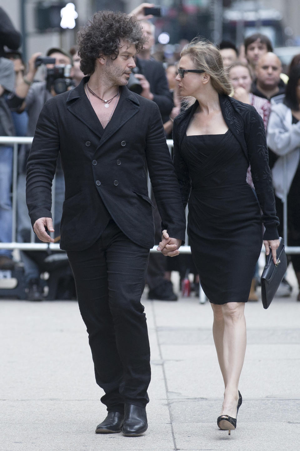 Renee Zellweger, right, and Doyle Bramhall arrive at St. Bartholomew's Church for a memorial service for fashion designer L'Wren Scott, Friday, May 2, 2014, in New York. Scott committed suicide on March 17 in her Manhattan apartment. (AP Photo/John Minchillo)
