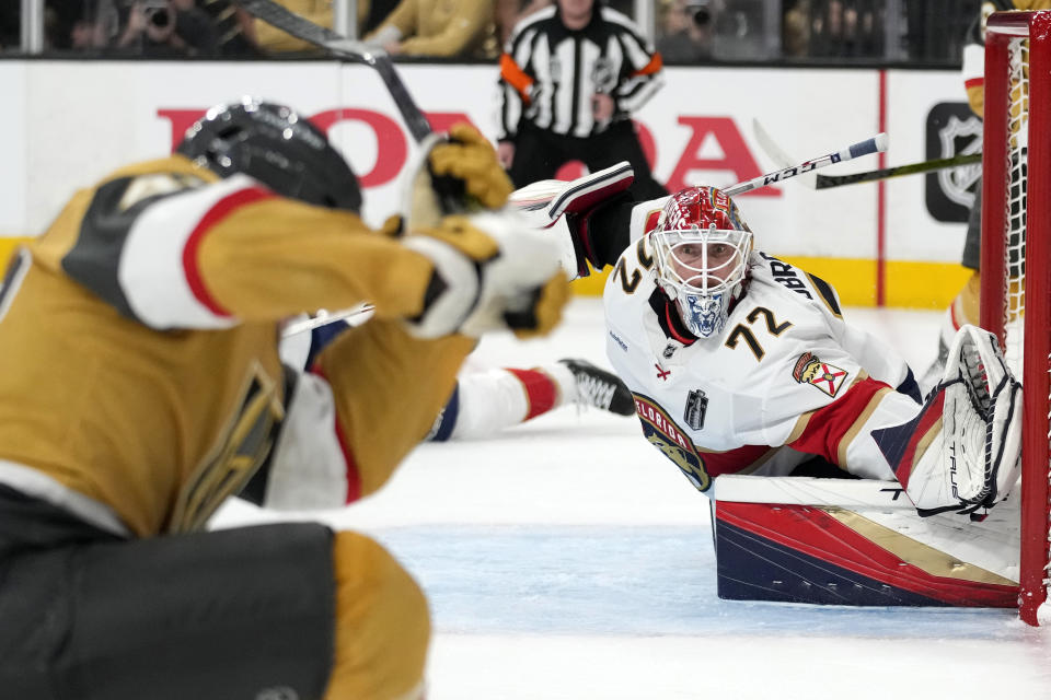 Vegas Golden Knights center Ivan Barbashev, left, tries to score on Florida Panthers goaltender Sergei Bobrovsky during the second period in Game 5 of the NHL hockey Stanley Cup Finals Tuesday, June 13, 2023, in Las Vegas. (AP Photo/John Locher)