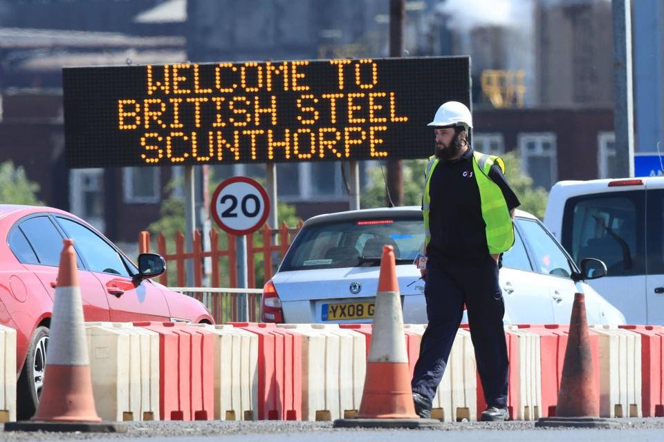 A worker at the entrance to the steelworks plant in Scunthorpe: PA