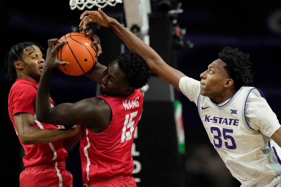 Kansas State forward Nae'Qwan Tomlin (35) goes for a steal against Radford's Madiaw Niang (15) on Wednesday at Bramlage Coliseum.