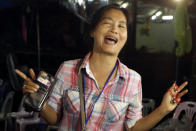 <p>A relative celebrates after 12 boys and their soccer coach were found alive in a cave complex in Mae Sai, Chiang Rai Province, northern Thailand, on July 2, 2018. Rescuers located 12 boys and their soccer coach alive deep inside the partially flooded cave more than a week after they went missing. (Photo: Sakchai Lalit/AP) </p>