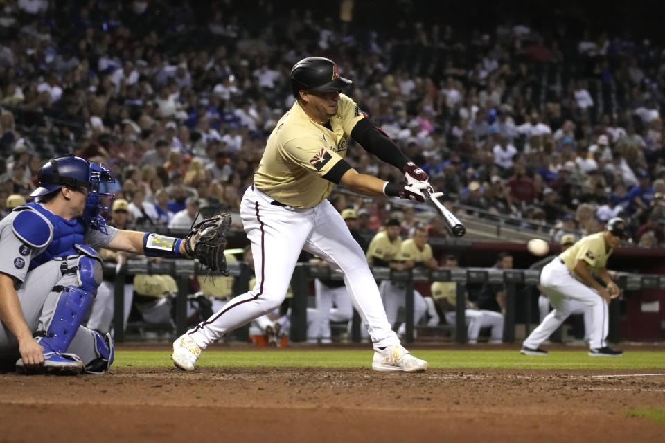 Arizona Diamondbacks' Asdrubal Cabrera hits an RBI single against the Los Angeles Dodgers during the fourth inning of a baseball game, Friday, July 30, 2021, in Phoenix. (AP Photo/Rick Scuteri)