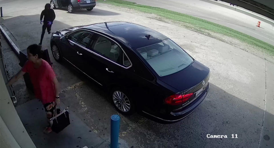 A man is seen running towards her after she exits her car. Source: Mark Herman, Harris County Constable Precinct 4/ Facebook