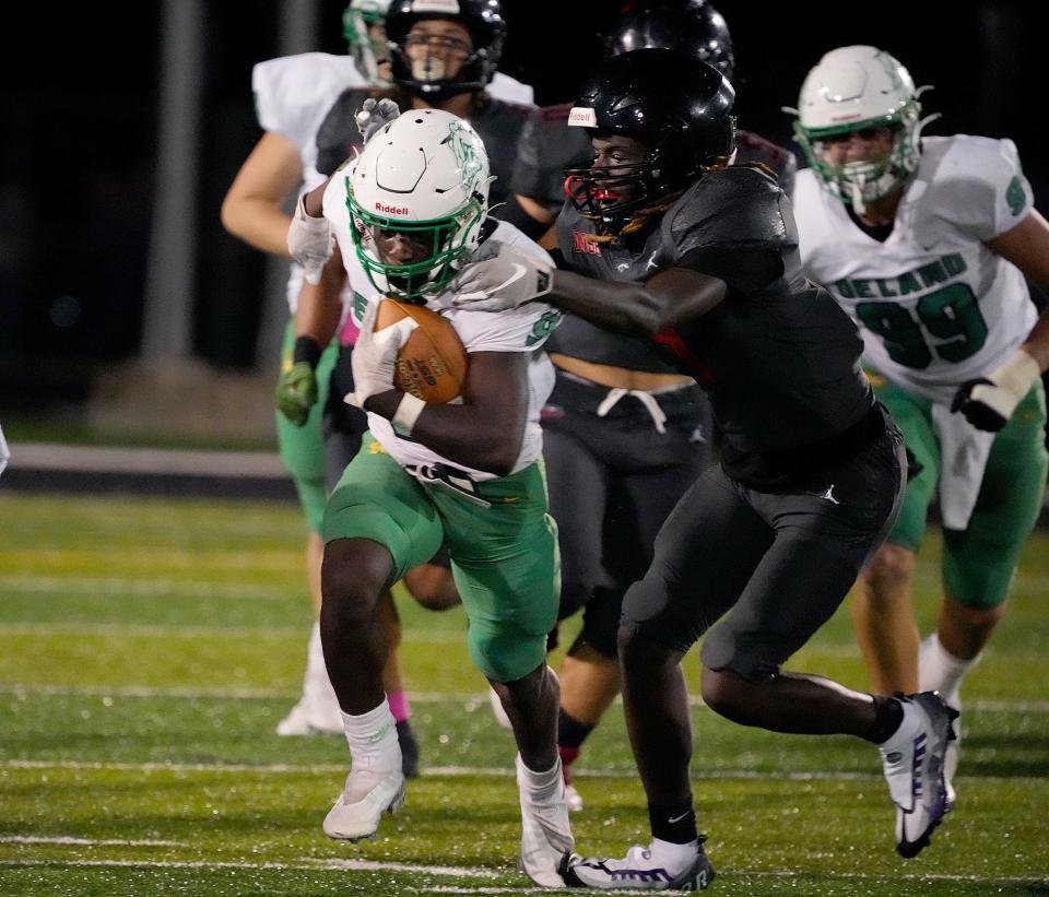 DeLand's Javon Ross scampers for yardage during a game with New Smyrna Beach at New Smyrna Sports Complex, Thursday, Oct. 27, 2022.