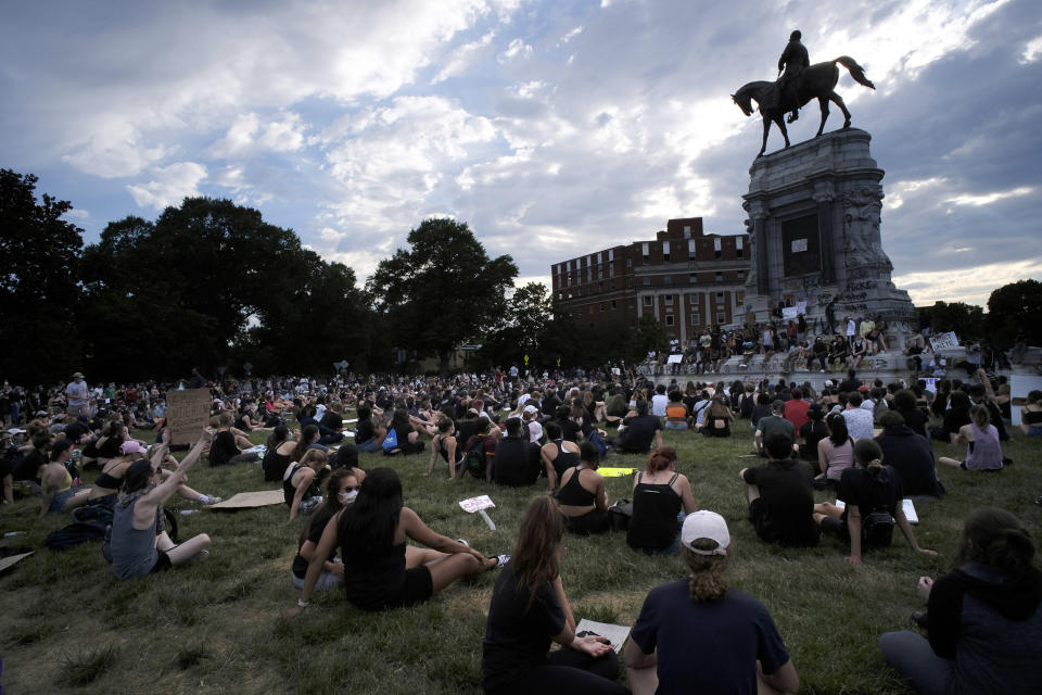 Image: Protesters sit near the statue of Robert E. Lee on Monument Avenue in Richmond, Va. (Bob Brown / AP)