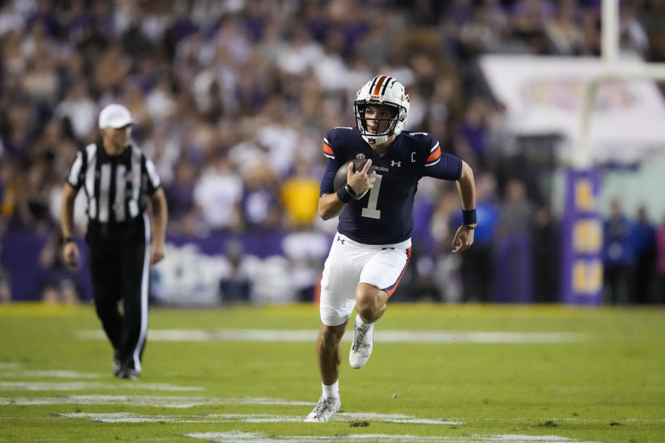 Auburn quarterback Payton Thorne (1) carries on a keeper for a long gain in the first half of an NCAA college football game against LSU in Baton Rouge, La., Saturday, Oct. 14, 2023. (AP Photo/Gerald Herbert)