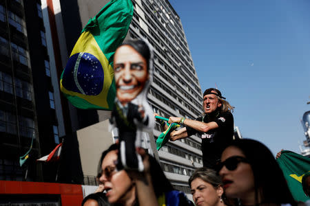 FILE PHOTO: A supporter of presidential candidate Jair Bolsonaro waves a Brazilian flag at Paulista Avenue, after Bolsonaro was stabbed in Juiz de Fora, in Sao Paulo, Brazil September 9, 2018. REUTERS/Nacho Doce