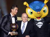 Portugal's Cristiano Ronaldo poses with FIFA President Sepp Blatter (C) and 2014 World Cup mascot Fuleco after being awarded the FIFA Ballon d'Or 2013 in Zurich January 13, 2014. Portugal and Real Madrid forward Cristiano Ronaldo was named the world's best footballer for the second time on Monday, preventing his great rival Lionel Messi from winning the award for a fifth year in a row. REUTERS/Arnd Wiegmann (SWITZERLAND - Tags: SPORT SOCCER)