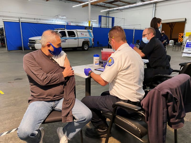 Jose Luis Espinoza looks on before receiving a dose of the Pfizer vaccine against the coronavirus disease (COVID-19) after waiting for a leftover one at a clinic in Santa Fe Springs, California, United States