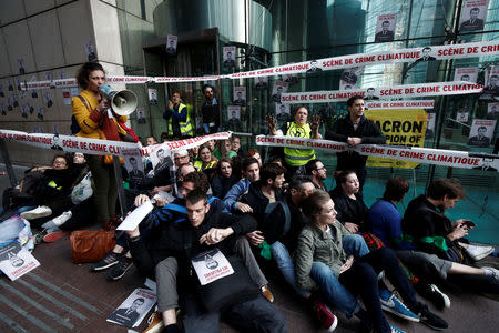 Environmental activists block the entrance of the French bank Societe Generale headquarters during a "civil disobedience action" to urge world leaders to act against climate change, in La Defense near Paris, France, April 19, 2019. REUTERS/Benoit Tessier