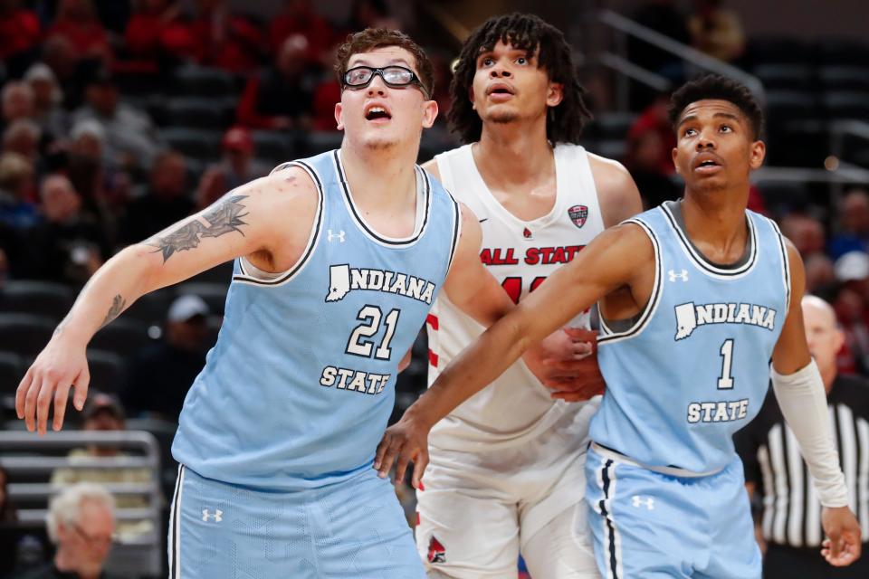 Indiana State Sycamores center Robbie Avila (21) and Indiana State Sycamores guard Julian Larry (1) box out Ball State Cardinals forward Basheer Jihad (11) during the NCAA men’s basketball game, Saturday, Dec. 16, 2023, at Gainbridge Fieldhouse in Indianapolis. Indiana State Sycamores won 83-72.