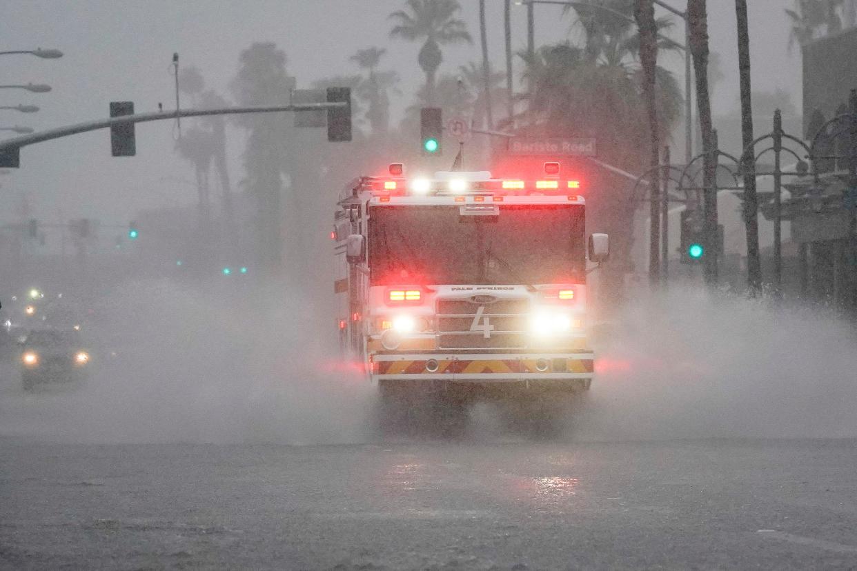 A fire engine responds to a call through standing water on Indian Canyon Drive as Tropical Storm Hilary approaches Palm Springs, California (REUTERS)