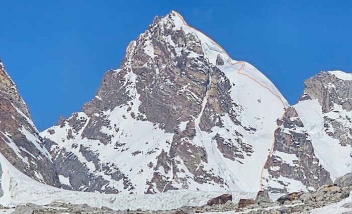 topo route in red on a photo of the previously unclimbed peak.