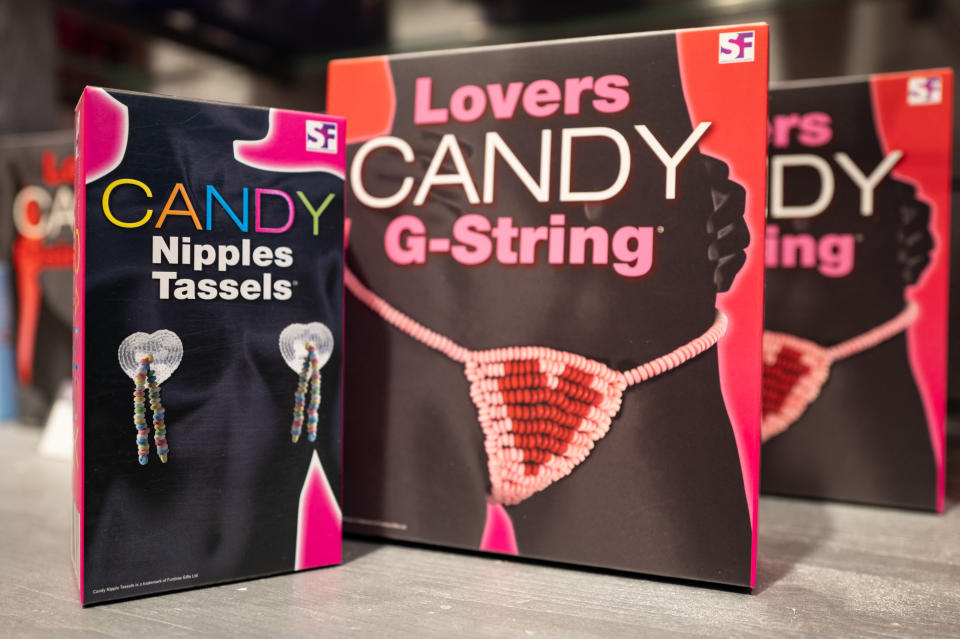 Product packaging for "Lovers Candy G-String" and "Candy Nipples Tassels" on display