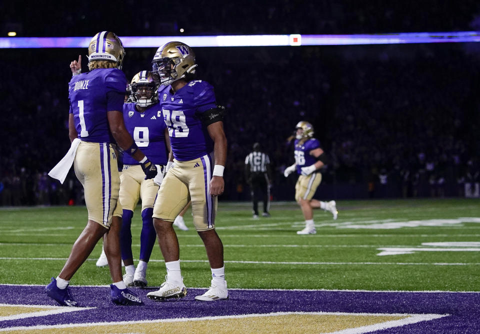 Washington wide receiver Rome Odunze (1) celebrates his touchdown against California with quarterback Michael Penix Jr. (9) and running back Sam Adams II (28) during the first half of an NCAA college football game Saturday, Sept. 23, 2023, in Seattle. (AP Photo/Lindsey Wasson)