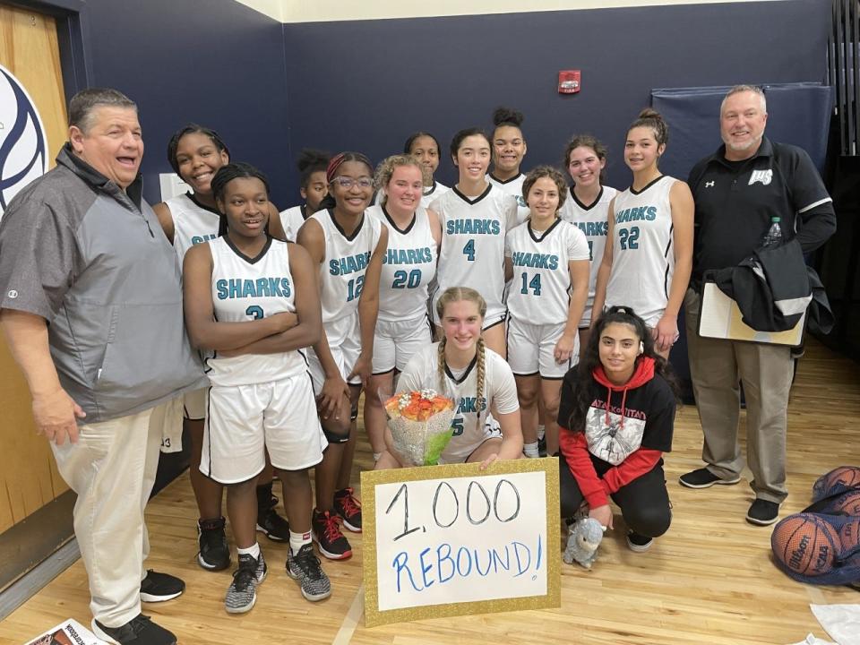 Veronica Sierzant of Islands (center) after recording her 1,000th career rebound against Savannah Country Day on Dec. 29.