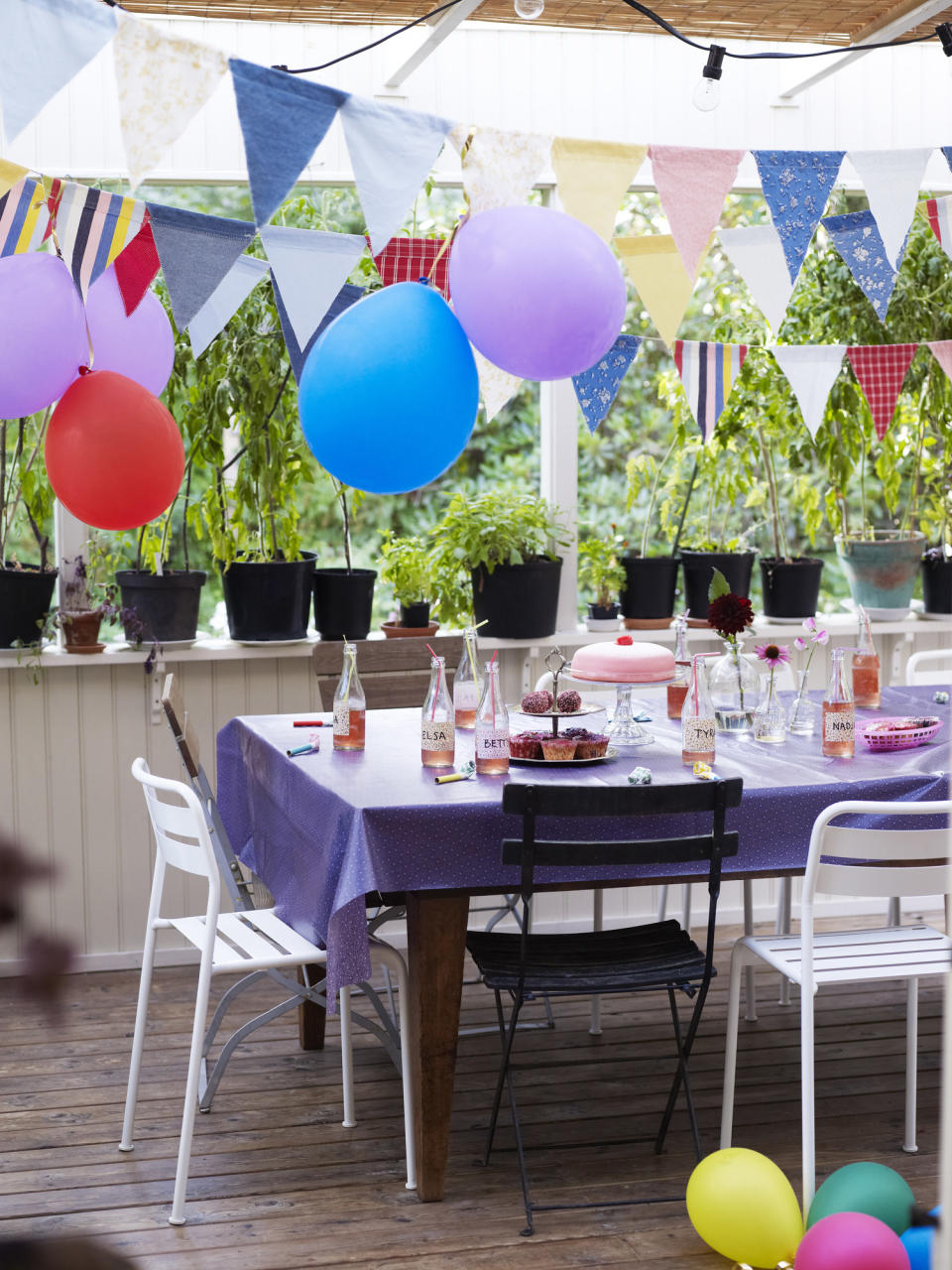 A birthday party set up on an outdoor deck.