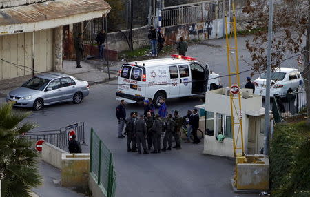 Israeli border policemen stand guard near the scene where a Palestinian man stabbed and critically wounded an Israeli before being shot dead by Israeli forces, in the West Bank city of Hebron December 7, 2015. REUTERS/Mussa Qawasma